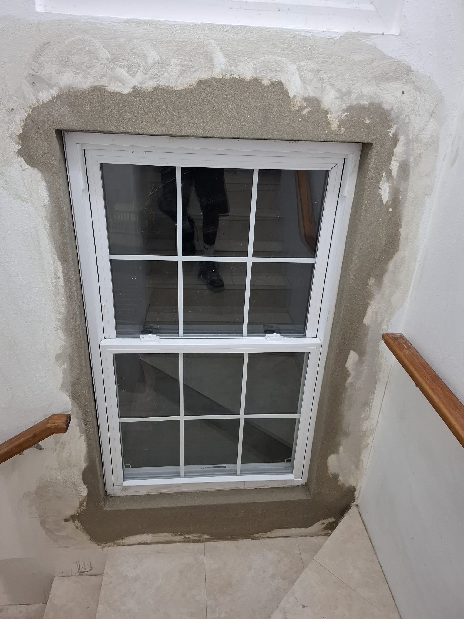 New window fitted with fresh render around the frame, ready for finishing